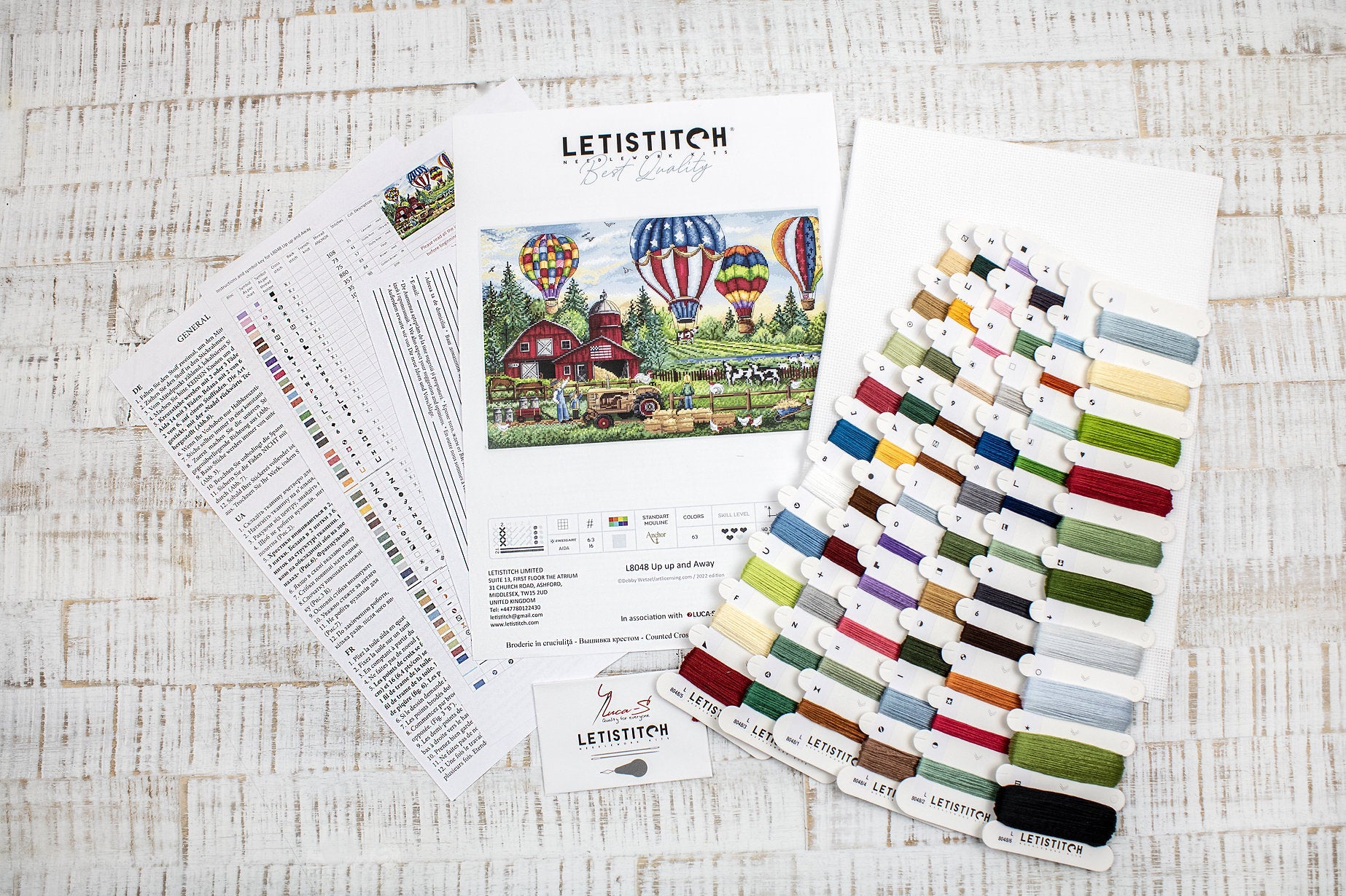 Up Up and Away L8048 Counted Cross Stitch Kit featuring colorful threads, Aida canvas, and detailed instruction chart.